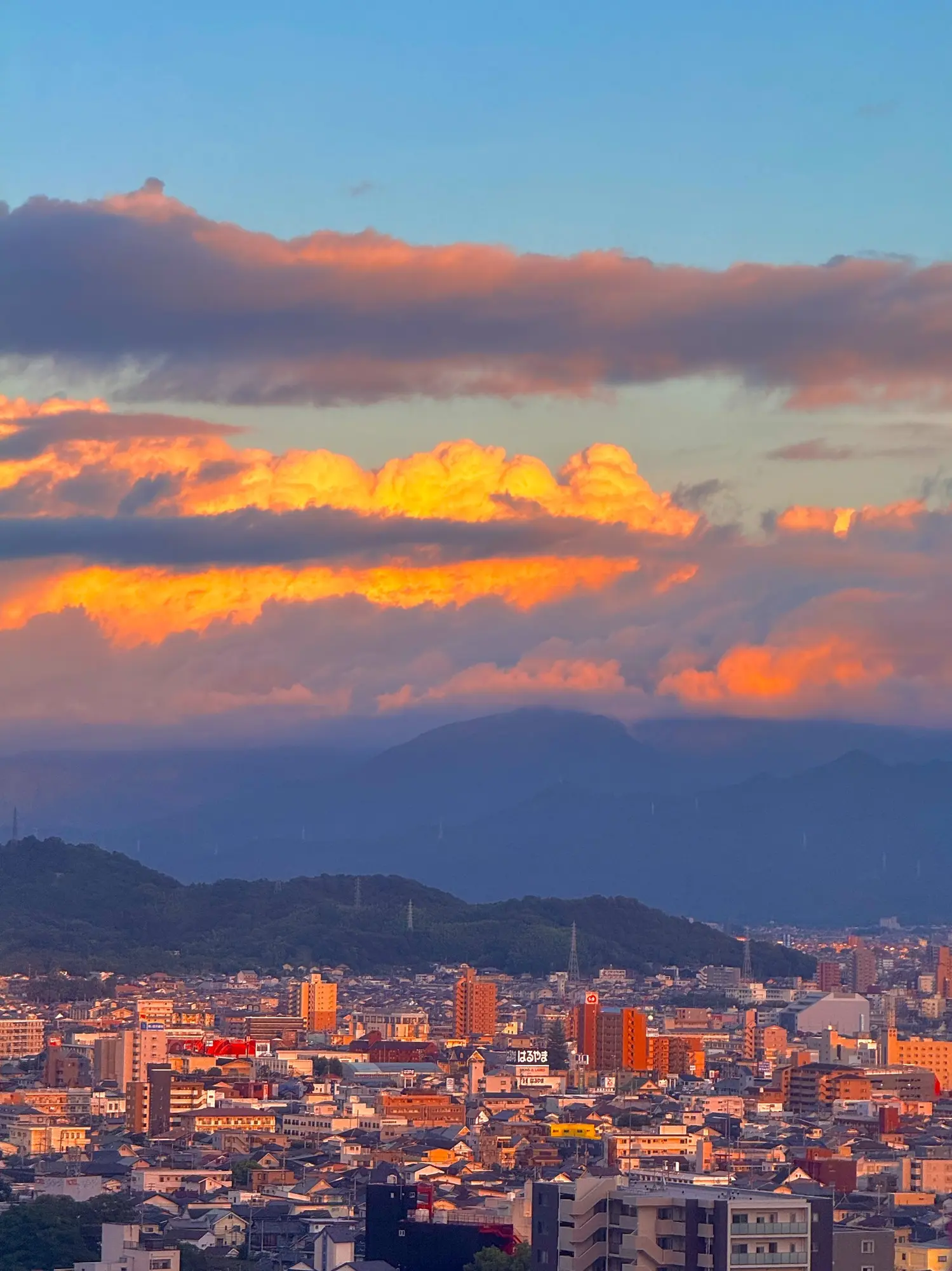 A city beneath glowing evening clouds
