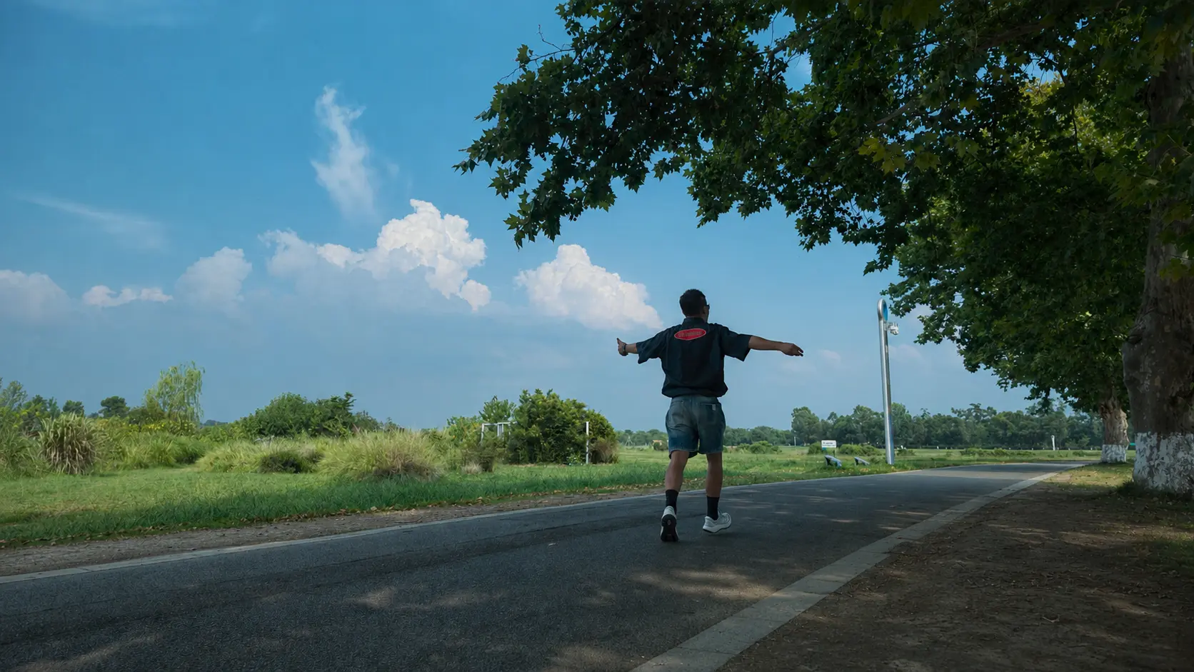 Bobby stepping forward beneath a wide blue sky